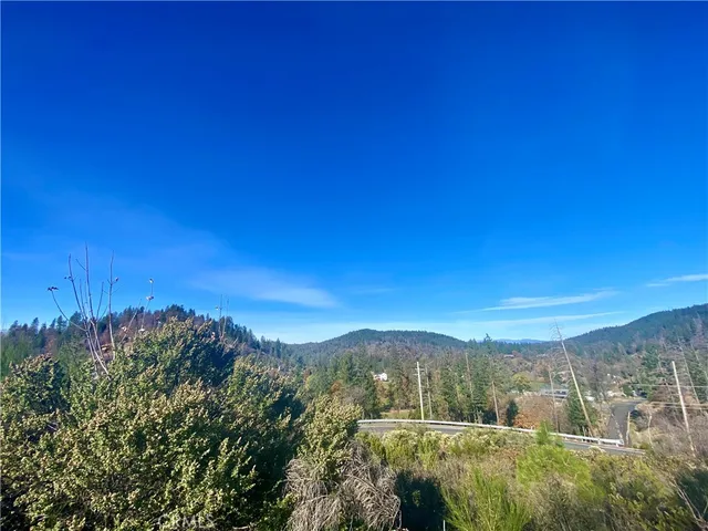 a view of a city with lush green forest
