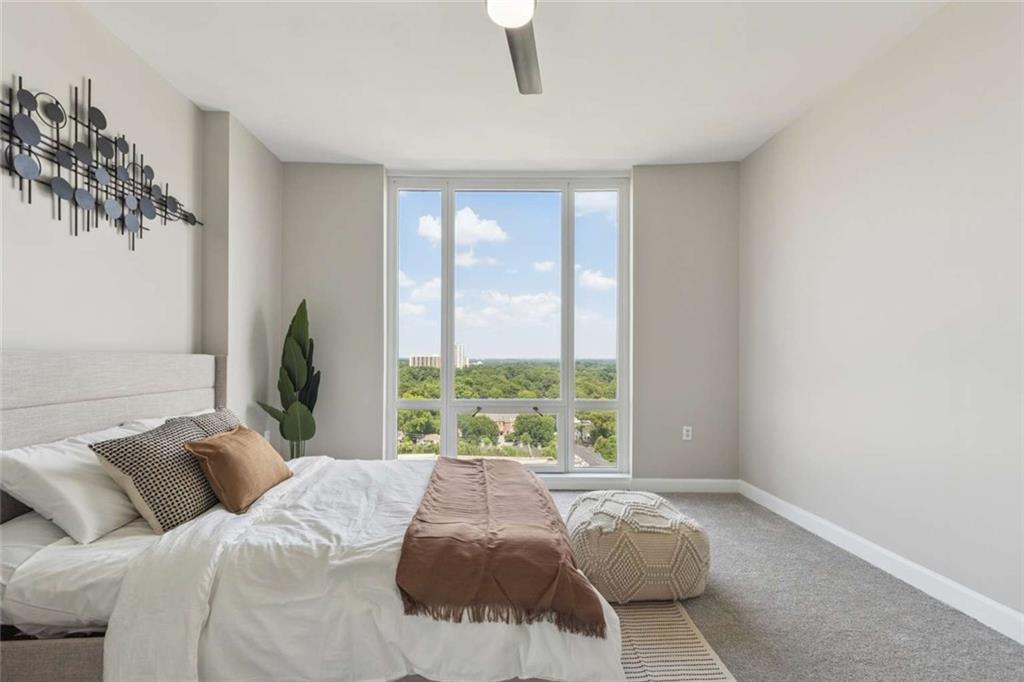 3475 Oak Valley Road Northeast, Unit 1570 Atlanta, GA 30326 - Photo 11 of 29 a bed sitting in a bedroom next to a window