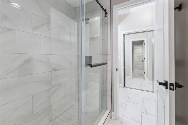 a bathroom with a glass shower door and a sink