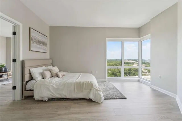 a bed room with a bed and a large window