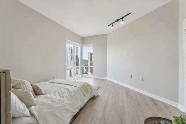 a spacious bedroom with a bed and a window