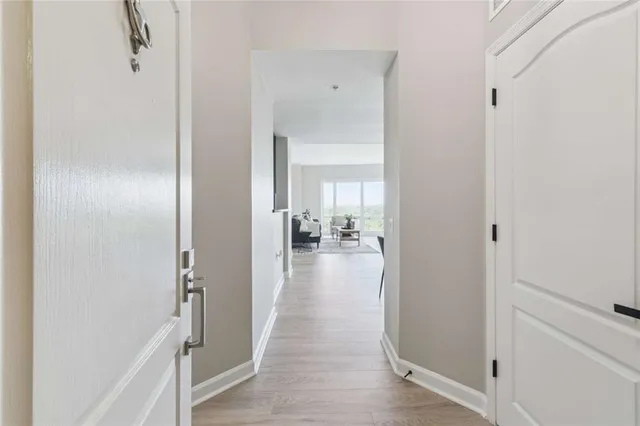a view of a hallway with a livingroom and couch