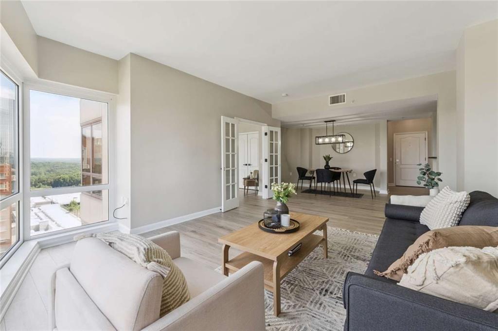 3475 Oak Valley Road Northeast, Unit 1570 Atlanta, GA 30326 - Photo 2 of 29 a living room with furniture and a table