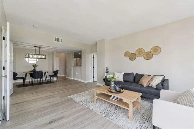 a living room with furniture and wooden floor
