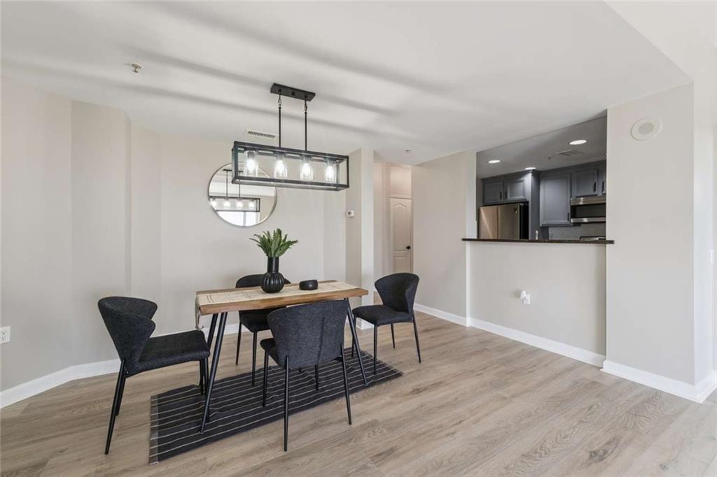 3475 Oak Valley Road Northeast, Unit 1570 Atlanta, GA 30326 - Photo 7 of 29 a view of a dining room with furniture and wooden floor