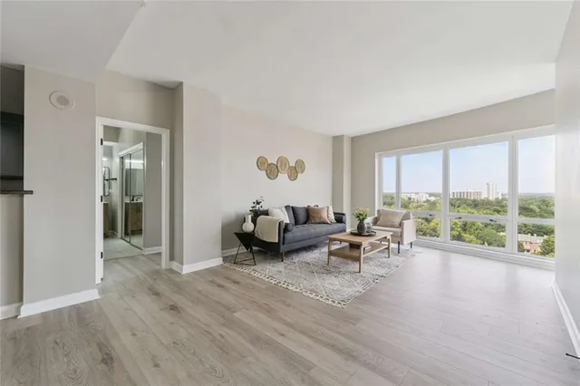 a living room with furniture and a large window
