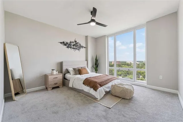 a spacious bedroom with a bed and a large window