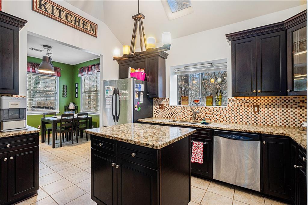 6507 Rebecca Way Lithonia, GA 30058 - Photo 11 of 31 a kitchen with a sink a counter and dining table
