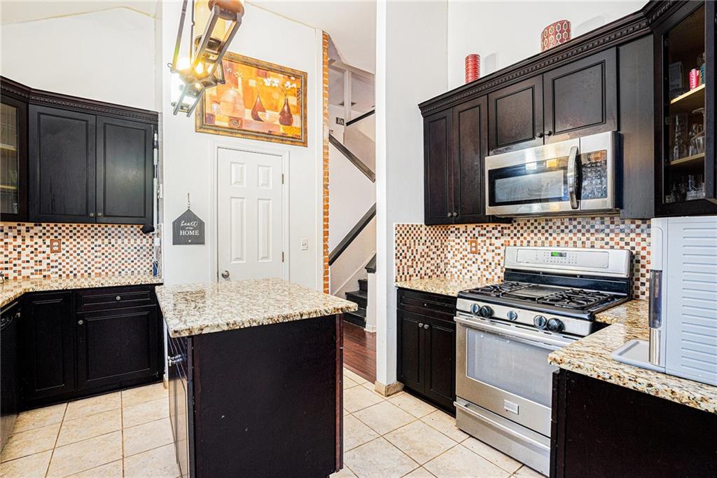 6507 Rebecca Way Lithonia, GA 30058 - Photo 12 of 31 a kitchen with a sink stove and cabinets