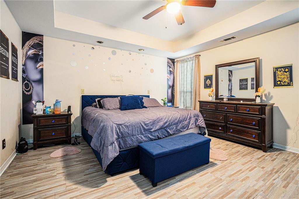 6507 Rebecca Way Lithonia, GA 30058 - Photo 14 of 31 a bedroom with a bed and wooden floor