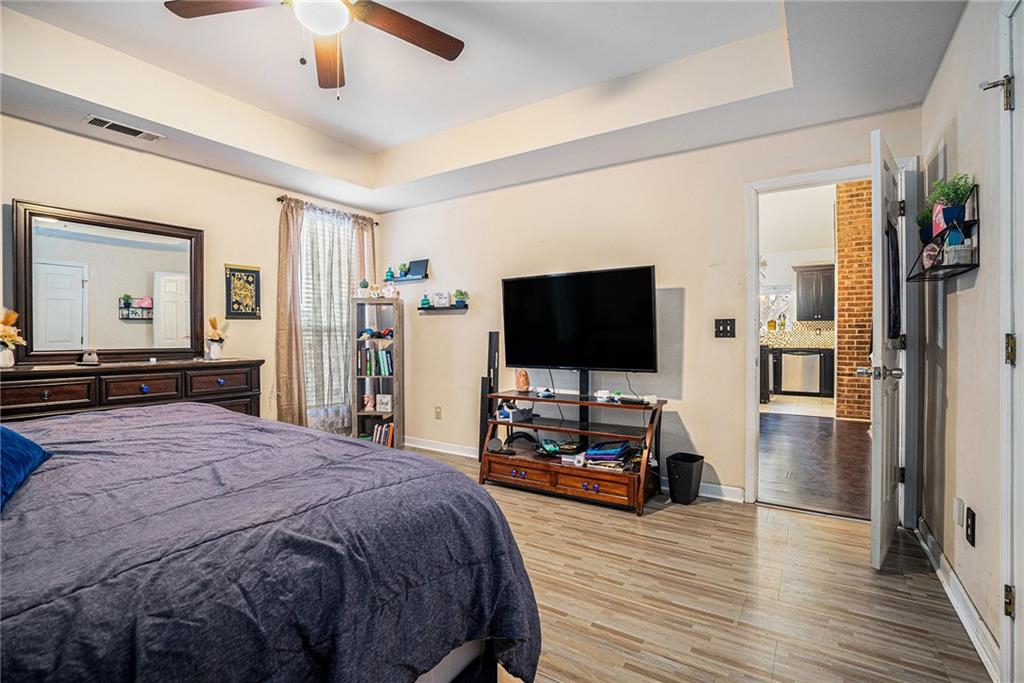 6507 Rebecca Way Lithonia, GA 30058 - Photo 15 of 31 a bedroom with a bed and a flat screen tv