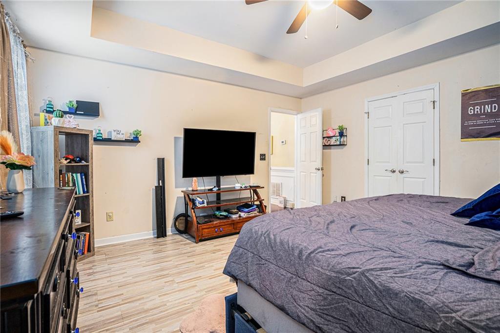 6507 Rebecca Way Lithonia, GA 30058 - Photo 16 of 31 a bedroom with a bed and a flat tv screen on dresser