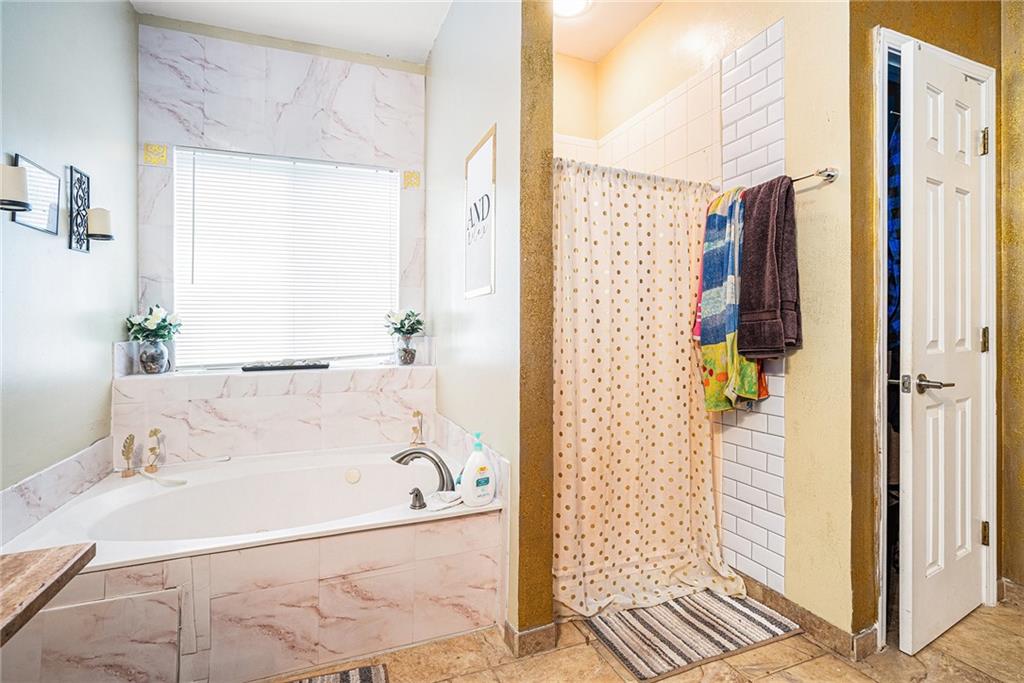 6507 Rebecca Way Lithonia, GA 30058 - Photo 18 of 31 a bathroom with a bathtub and a shower