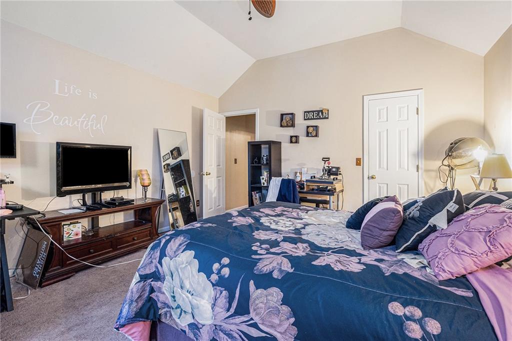 6507 Rebecca Way Lithonia, GA 30058 - Photo 21 of 31 a bedroom with a bed and a flat screen tv