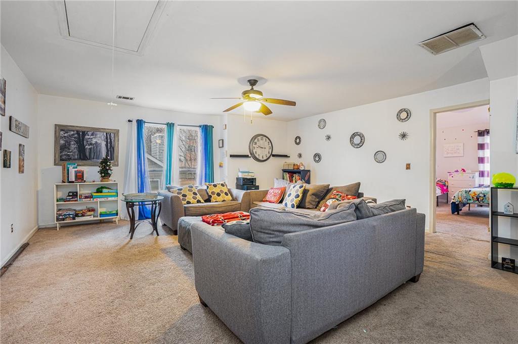 6507 Rebecca Way Lithonia, GA 30058 - Photo 25 of 31 a living room with furniture and a chandelier