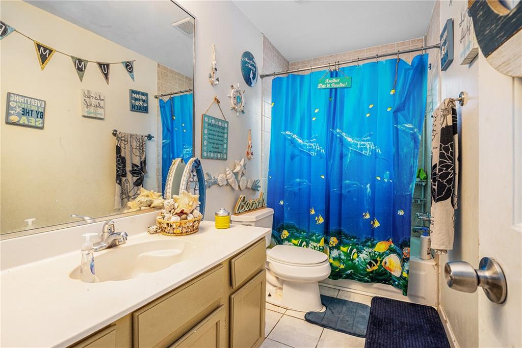 6507 Rebecca Way Lithonia, GA 30058 - Photo 28 of 31 a bathroom with a sink toilet and shower
