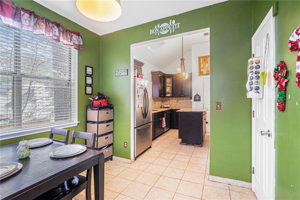 6507 Rebecca Way Lithonia, GA 30058 - Photo 9 of 31 a open kitchen with a table and chairs in it