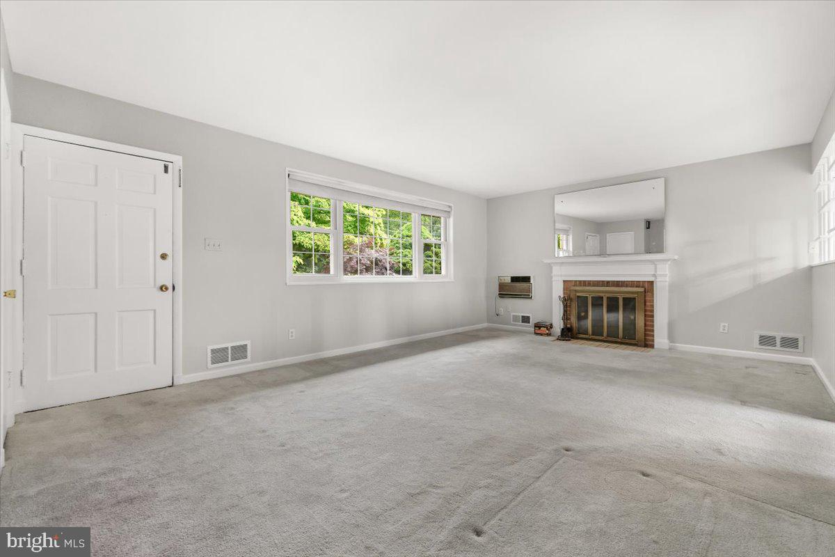 704 Ednor Road Ashton, MD 20861 - Photo 12 of 39 an empty room with windows and fireplace