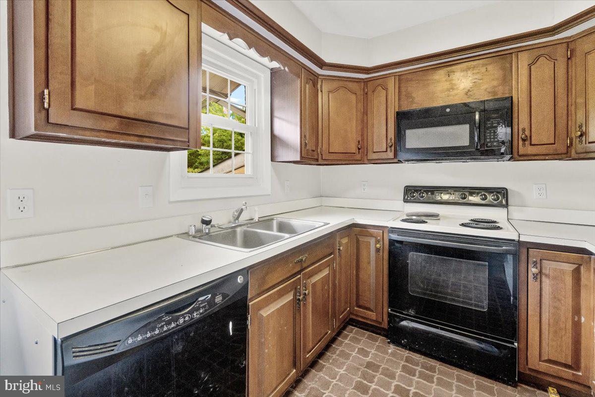704 Ednor Road Ashton, MD 20861 - Photo 16 of 39 a kitchen with stainless steel appliances a stove microwave and sink