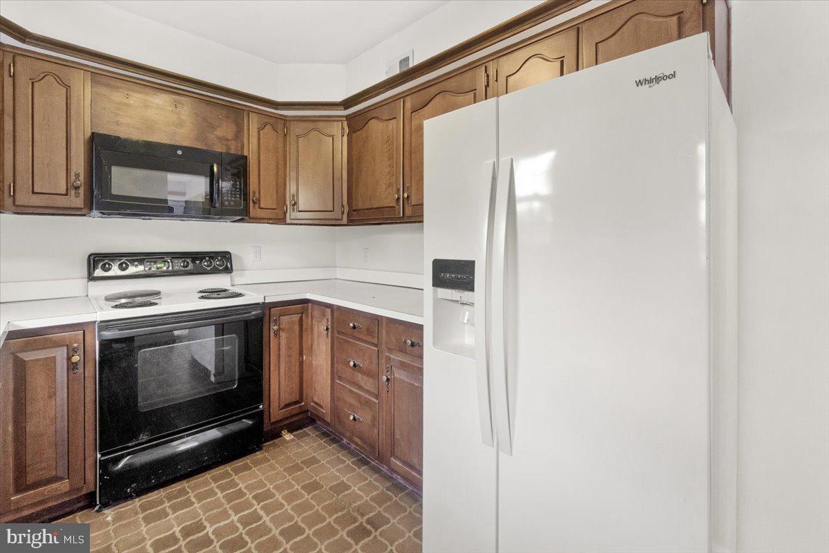 704 Ednor Road Ashton, MD 20861 - Photo 17 of 39 a kitchen with a refrigerator stove and microwave
