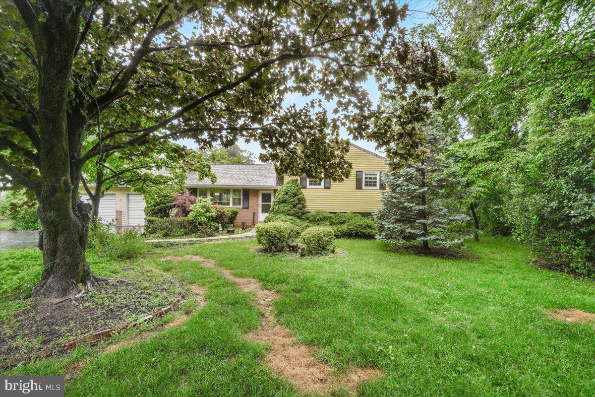 704 Ednor Road Ashton, MD 20861 - Photo 2 of 39 a view of a house with backyard and a sitting area