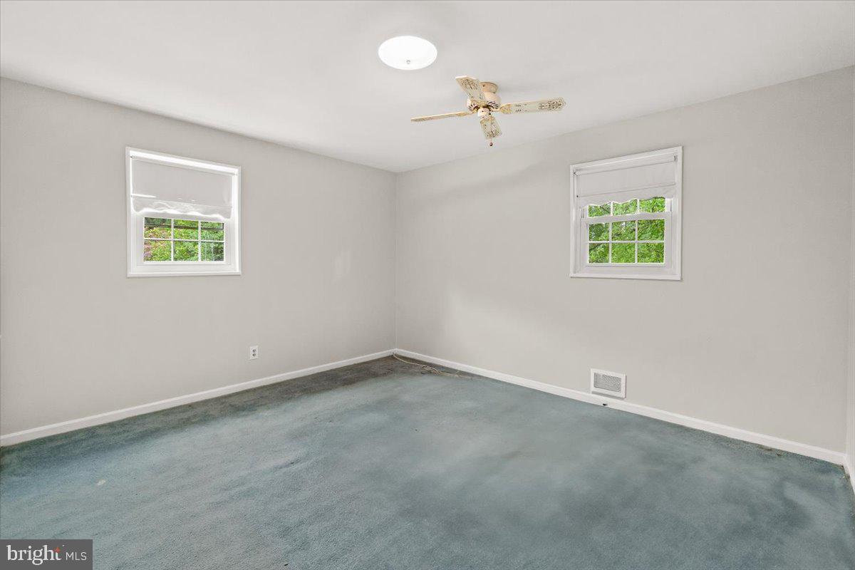 704 Ednor Road Ashton, MD 20861 - Photo 22 of 39 an empty room with windows and fan