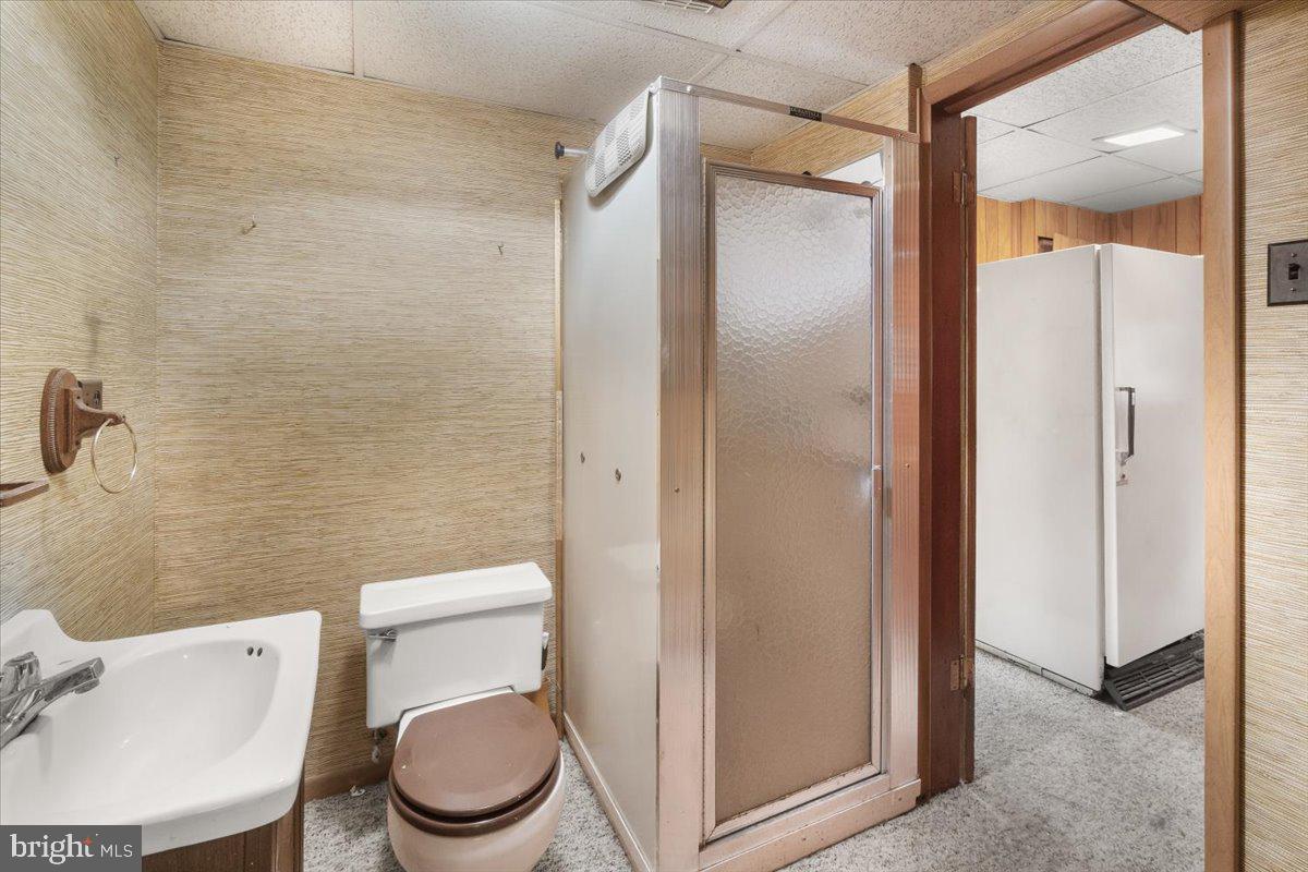 704 Ednor Road Ashton, MD 20861 - Photo 34 of 39 a white toilet sitting next to a bathroom sink