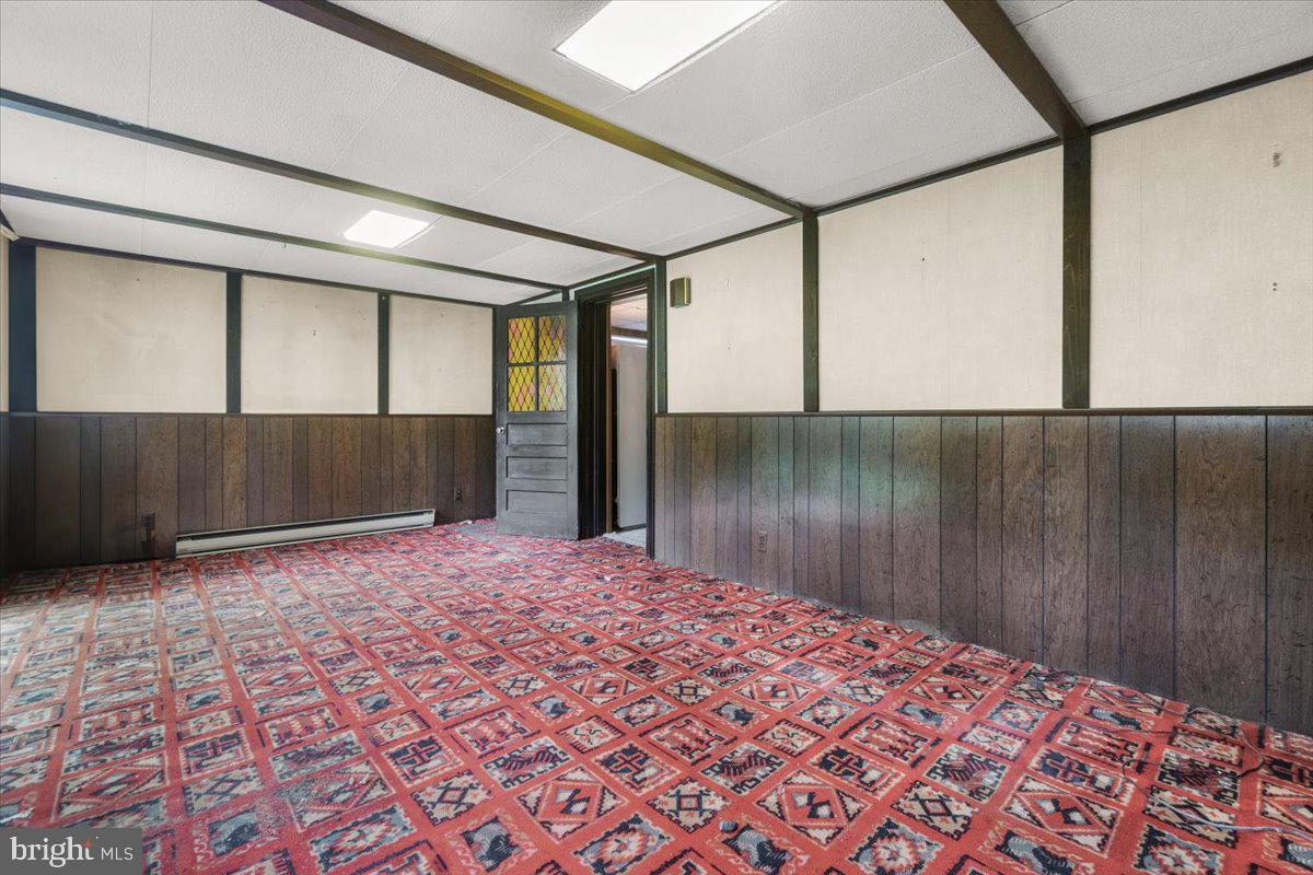 704 Ednor Road Ashton, MD 20861 - Photo 36 of 39 a view of a big room with wooden floor and a cabinet