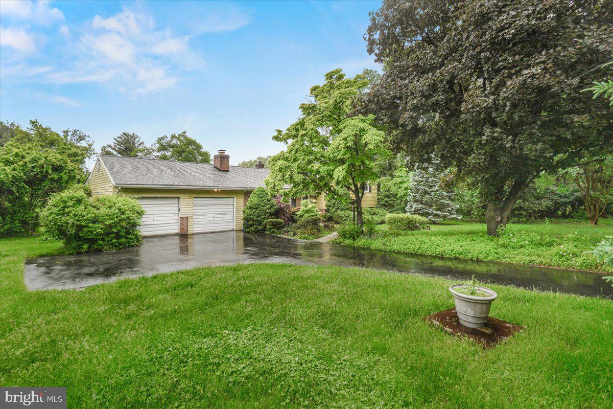 704 Ednor Road Ashton, MD 20861 - Photo 8 of 39 a view of a backyard with a garden and fire pit
