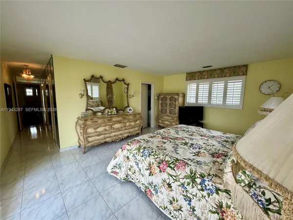 a bedroom with double bed and a dresser
