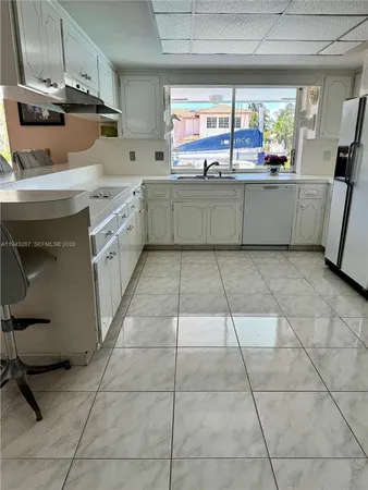 a kitchen with stainless steel appliances granite countertop a sink and cabinets