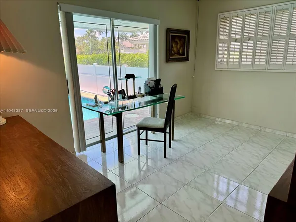 a view of a dining room with furniture and a window