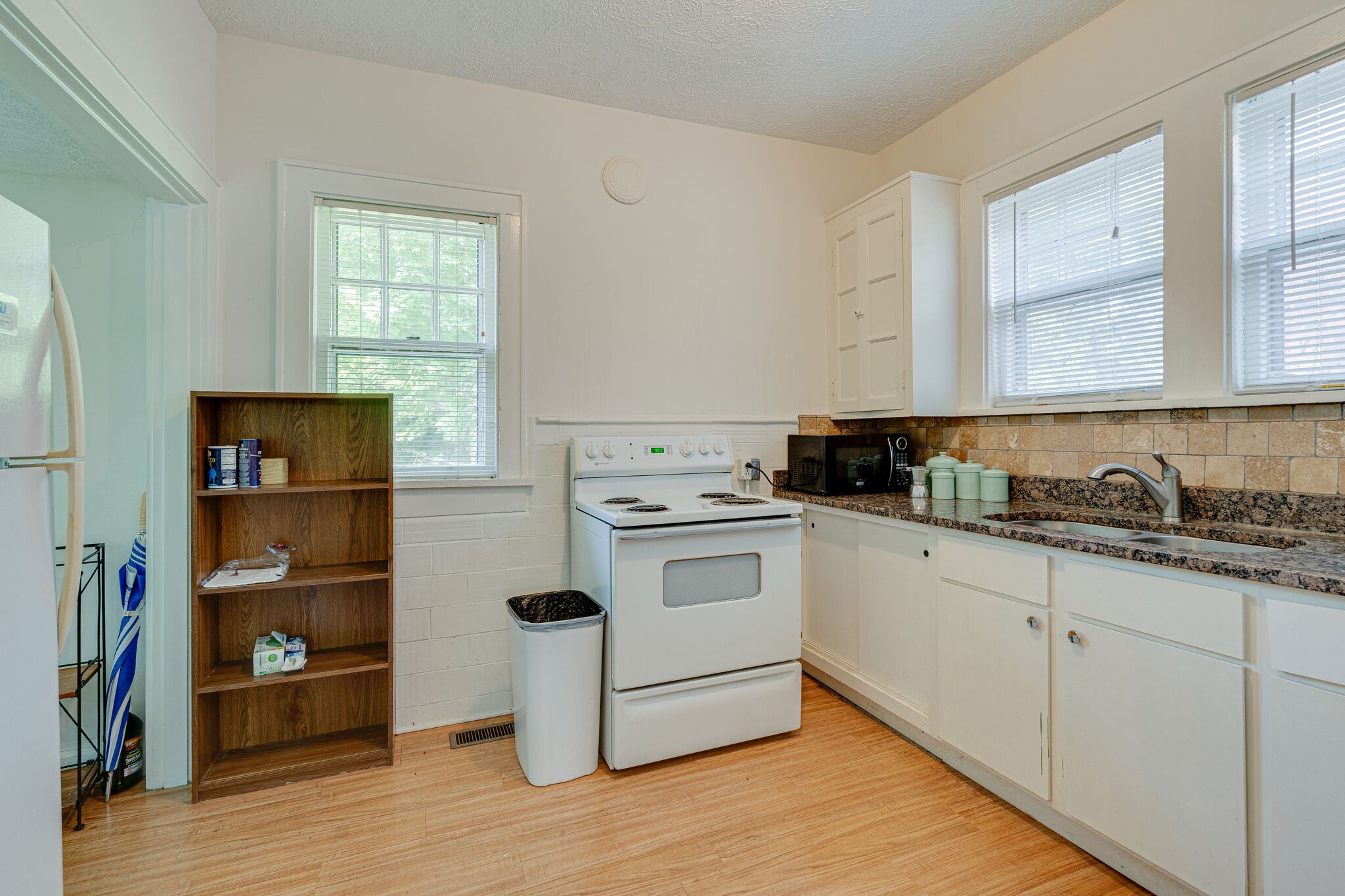 233 Cherokee Road Nashville, TN 37205 - Photo 14 of 29 a kitchen with granite countertop white cabinets and white appliances
