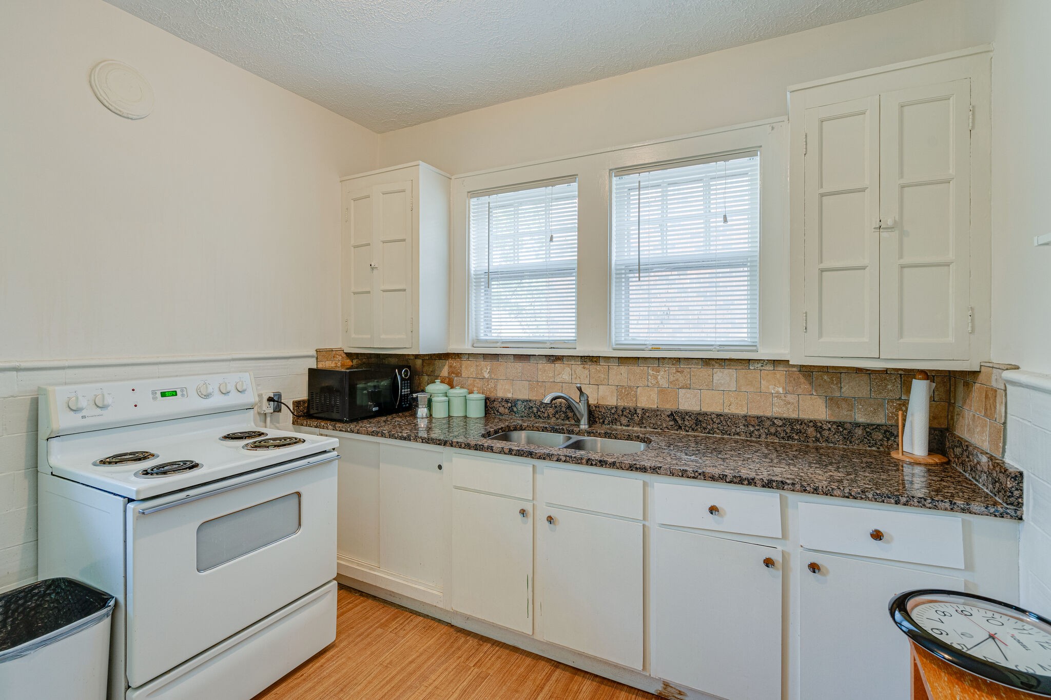 233 Cherokee Road Nashville, TN 37205 - Photo 15 of 29 a kitchen with granite countertop a sink cabinets and stainless steel appliances