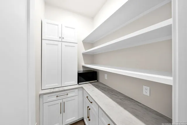 a bedroom with a bed and chandelier