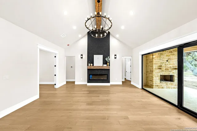 a large white kitchen with a large window and stainless steel appliances