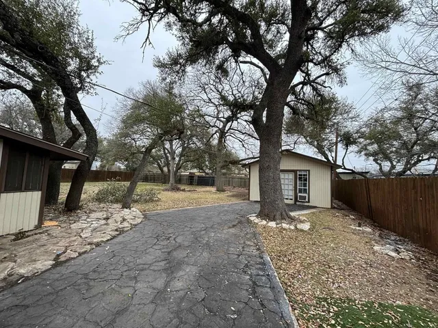 a front view of a house with a yard covered with snow