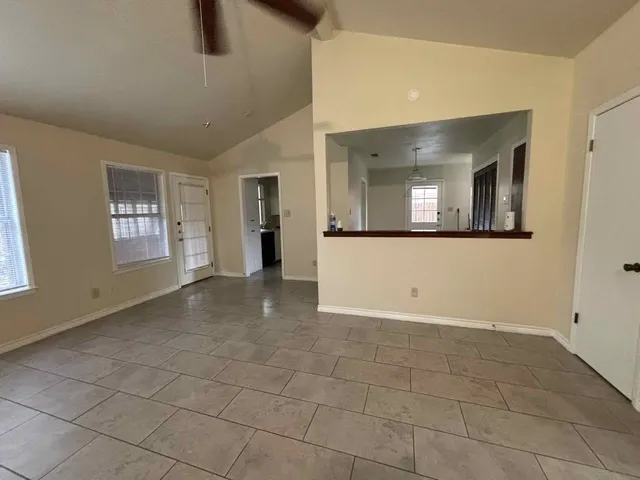 a view of a big room with windows and chandelier