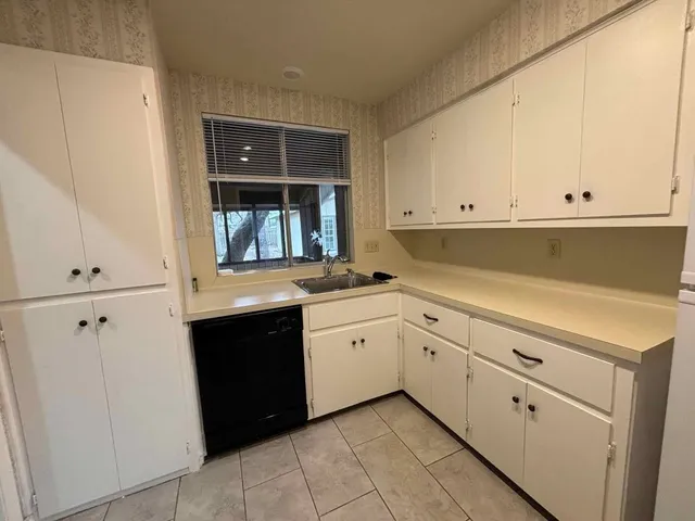 a kitchen with sink cabinets and refrigerator