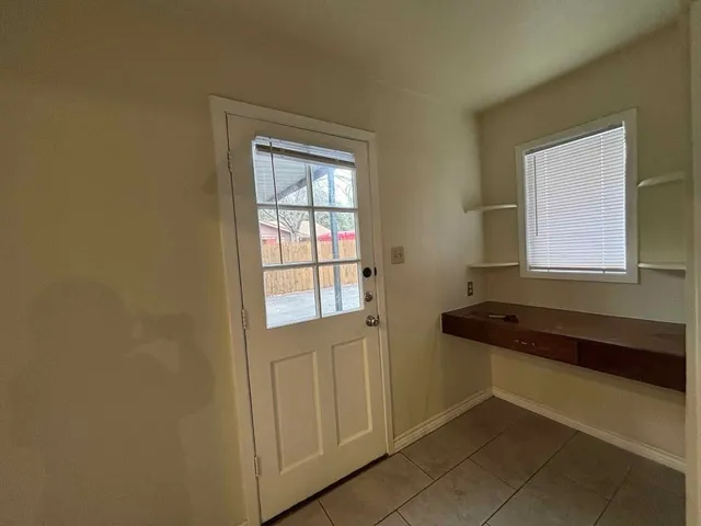 a kitchen with a refrigerator and a window