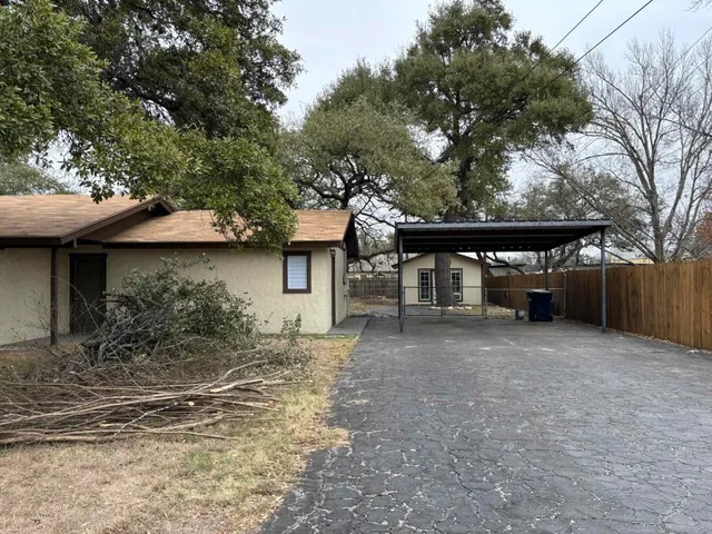 a view of house with trees in front of it