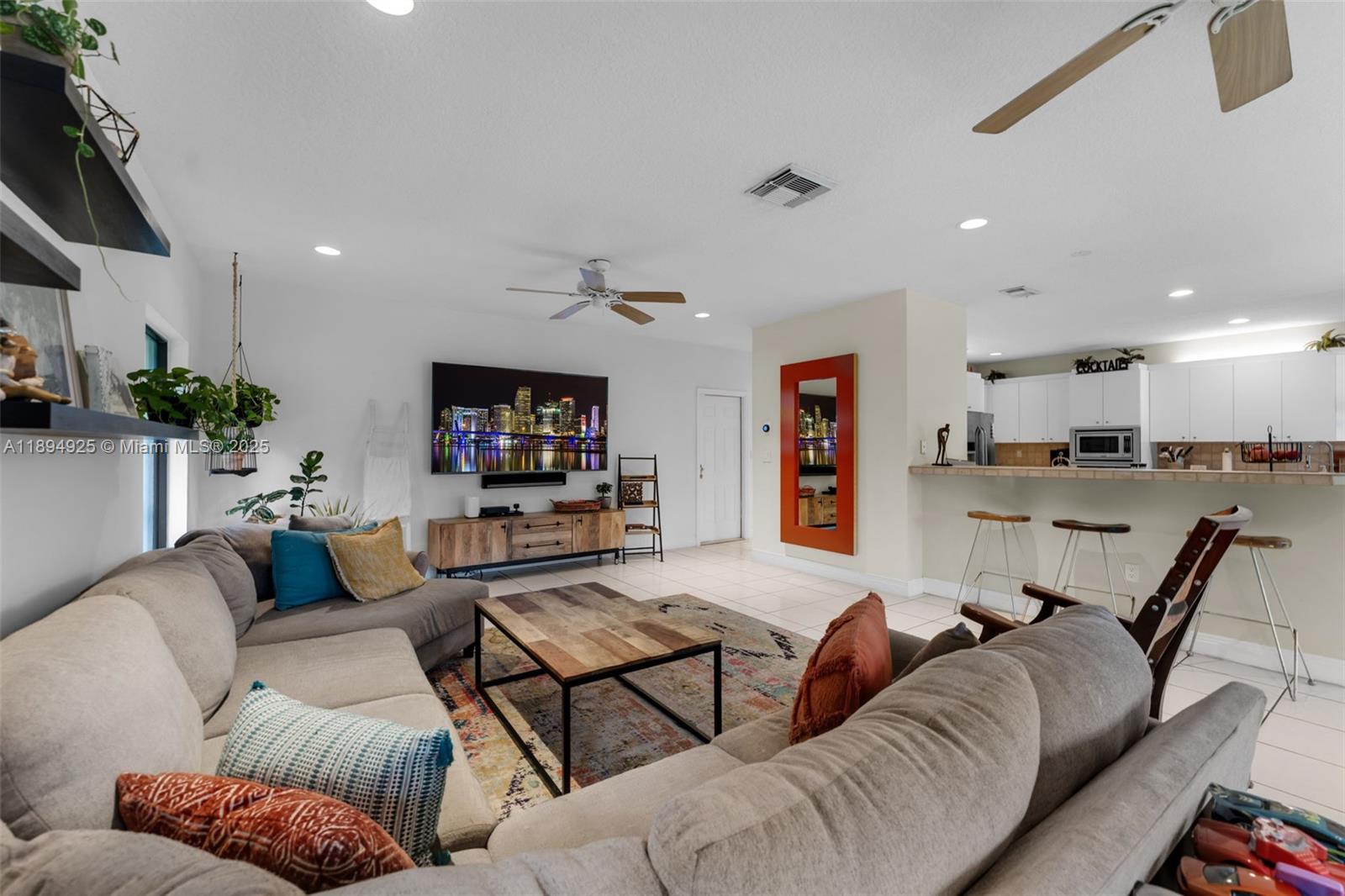 12019 Southwest 77th Terrace Miami, FL 33183 - Photo 16 of 67 a living room with furniture kitchen view and a flat screen tv