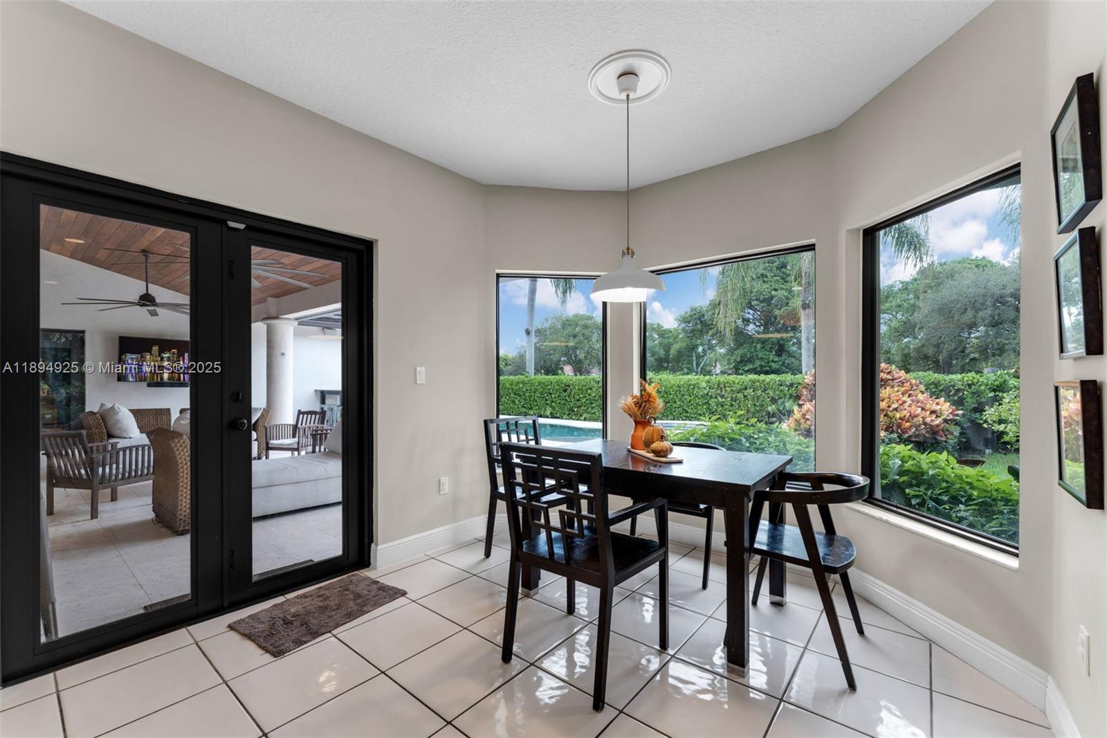 12019 Southwest 77th Terrace Miami, FL 33183 - Photo 17 of 67 a view of a dining room with furniture large window and chandelier