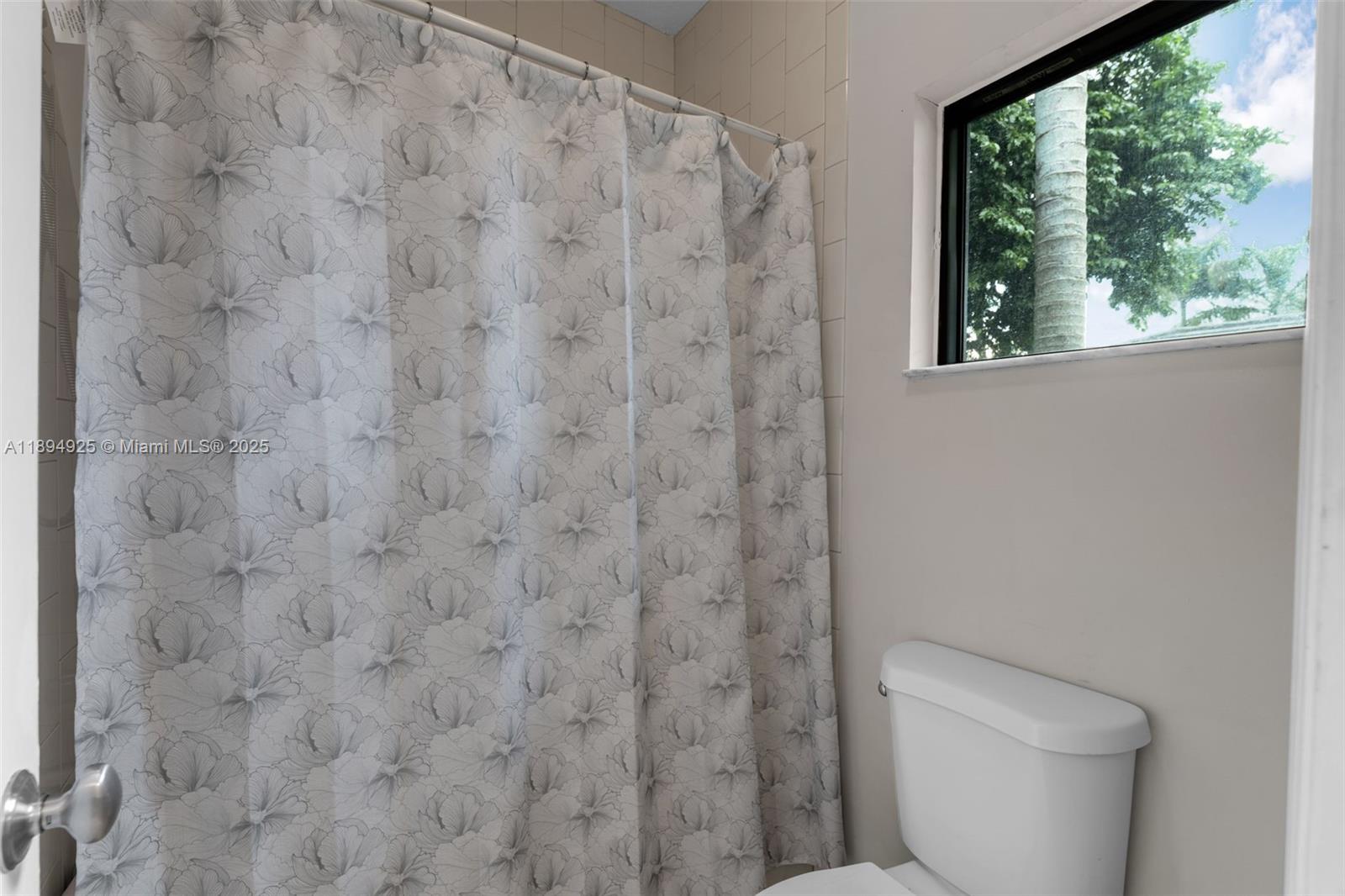 12019 Southwest 77th Terrace Miami, FL 33183 - Photo 25 of 67 a white toilet sitting next to a shower curtain