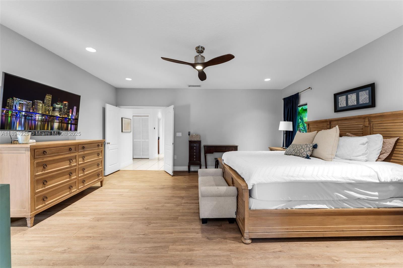 12019 Southwest 77th Terrace Miami, FL 33183 - Photo 34 of 67 a spacious bedroom with a bed and dresser