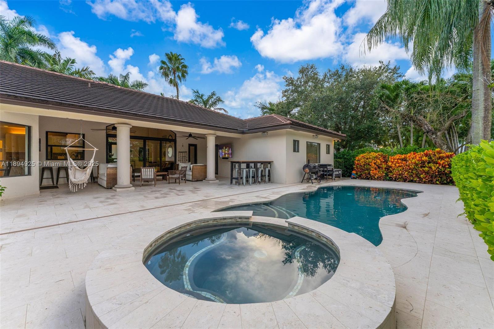 12019 Southwest 77th Terrace Miami, FL 33183 - Photo 46 of 67 a view of a house with pool fire pit and chairs in patio