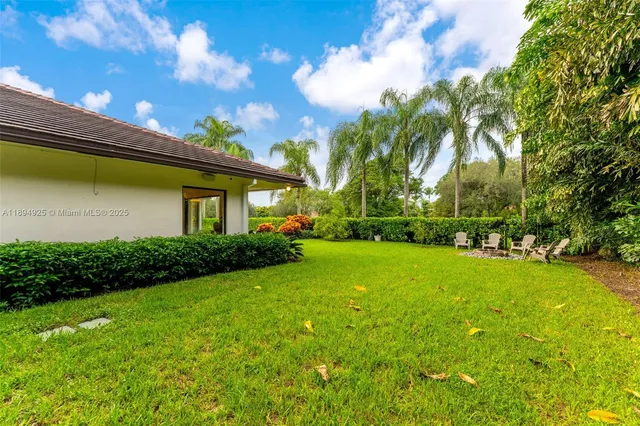 a living room with furniture a patio and a garden view