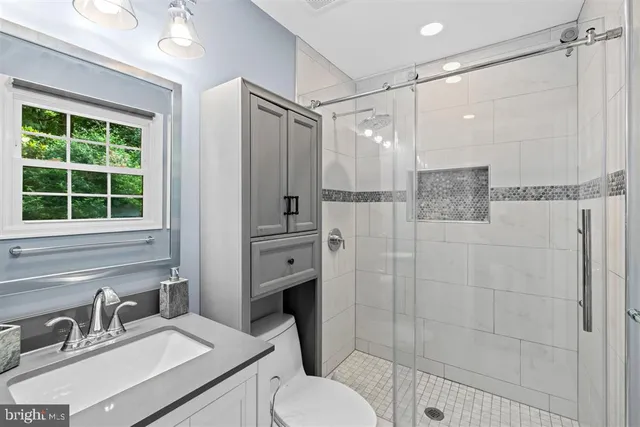 a bathroom with a sink toilet and shower