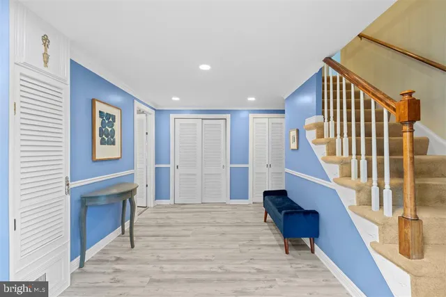 a view of entryway and hall with wooden floor