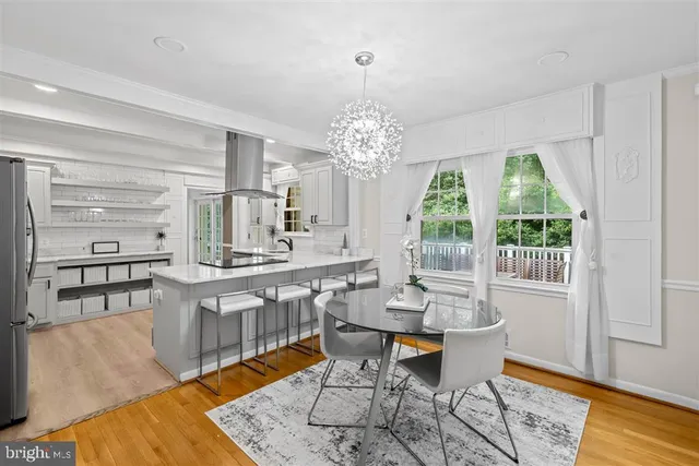 a dining room with furniture a rug and wooden floor